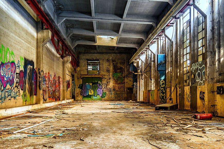 Abandoned Industrial Factory Hall With Colorful Graffiti And Decay