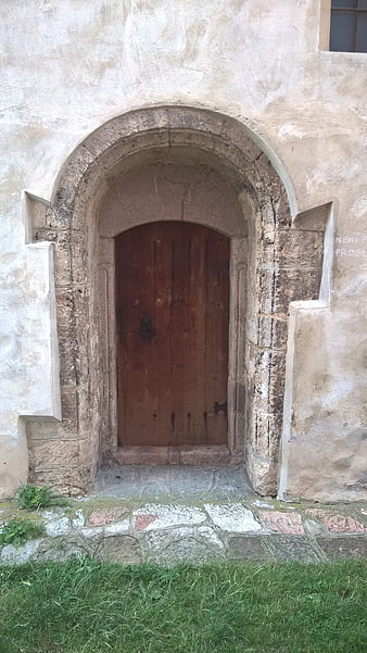 Old Wooden Church Door in Stone Archway