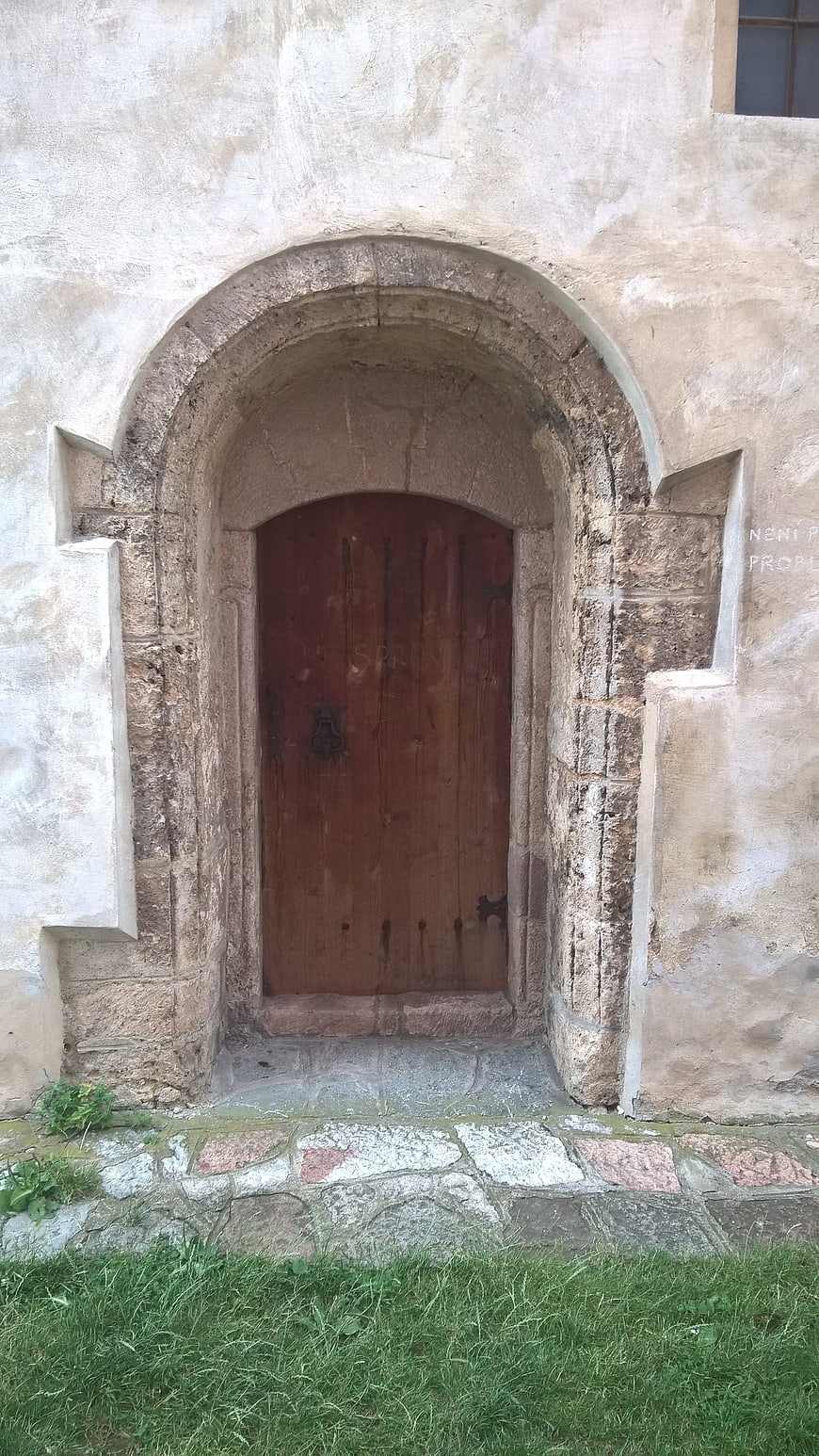 Old Wooden Church Door in Stone Archway