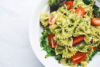 Farfalle Pesto Pasta with Cherry Tomatoes on White Plate
