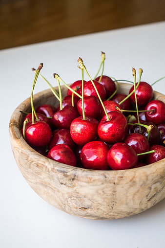 Fresh Red Cherries in a Rustic Wooden Bowl