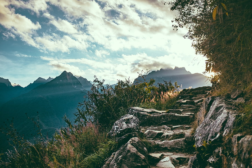 Rugged Mountain Trail with Dramatic Cloudy Sky