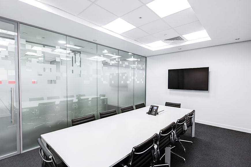 Modern Empty Conference Room with White Table and Glass Walls