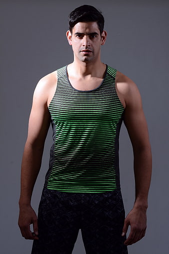 Portrait of a male fitness coach in a green striped tank top