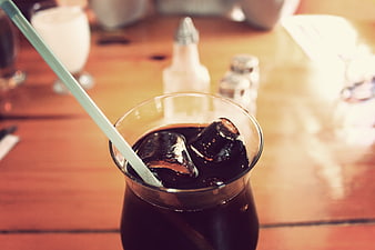Iced Coffee with Straw on Wooden Table
