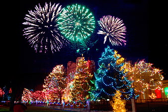 Fireworks Exploding Over Christmas Lights and Church at Night