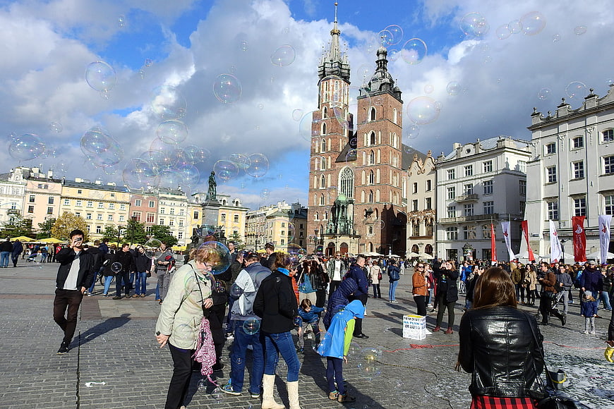 Soap bubbles floating in Krakow Main Market Square with St. Mary's Basilica