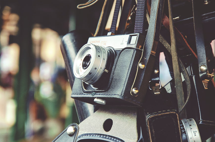 Vintage Film Camera in Leather Case Hanging on Strap