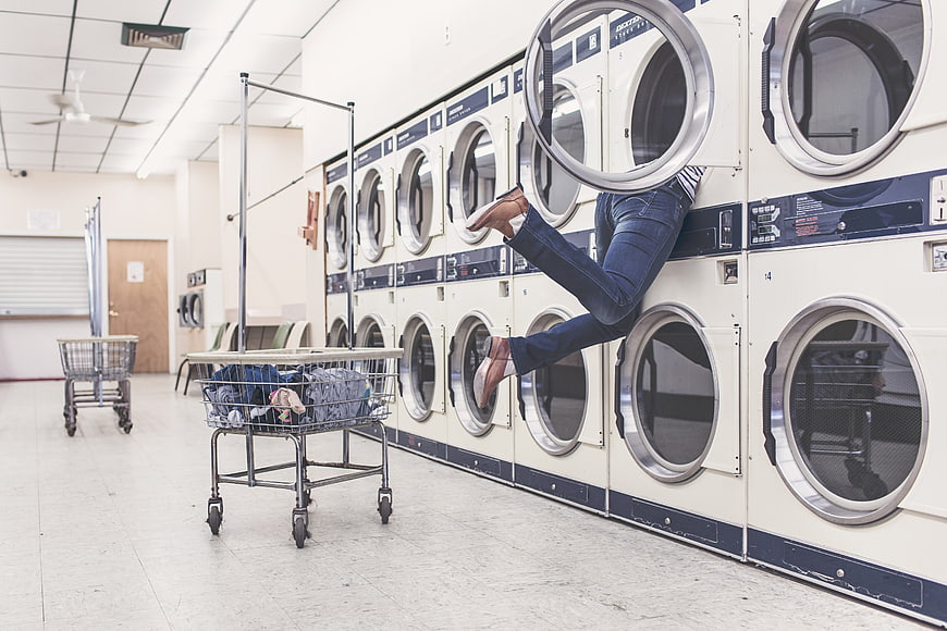 Woman Hiding Inside Laundry Machine at Laundromat