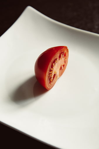 Fresh Red Tomato Half on White Plate