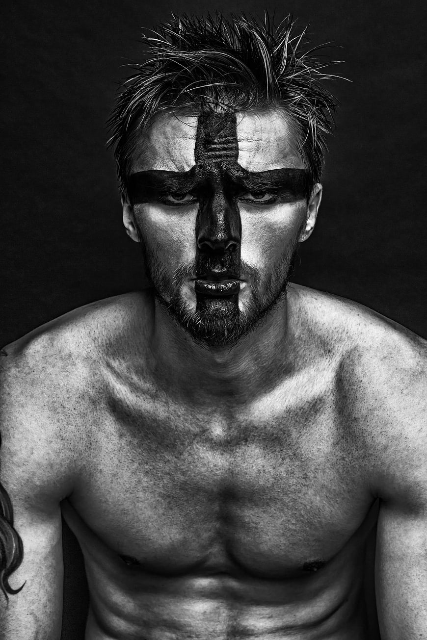 Dramatic Black and White Portrait of Man with Face Paint