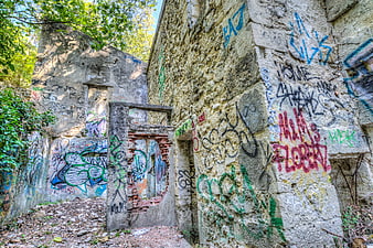 Abandoned concrete ruins covered in colorful graffiti art