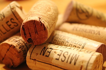 Close-up of wine corks with text on wooden background