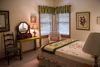Vintage Bedroom Interior With Floral Bedding And Antique Dressing Table