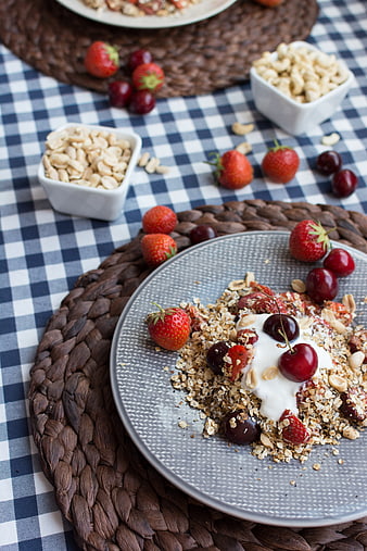 Healthy granola bowl with yogurt, strawberries, and cherries