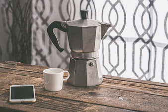 Vintage Moka Pot, White Mug, and Smartphone on Rustic Wooden Table
