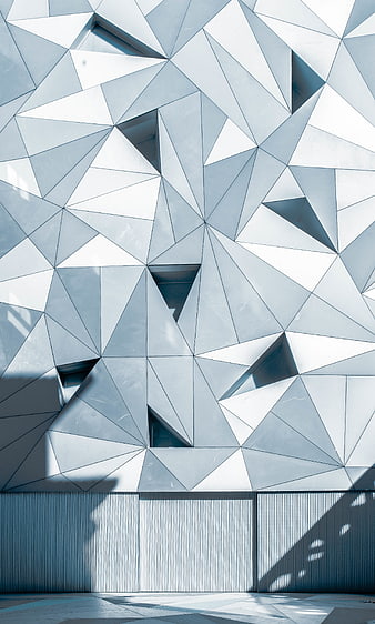 Modern Geometric Facade with Triangular Patterns and Shadows