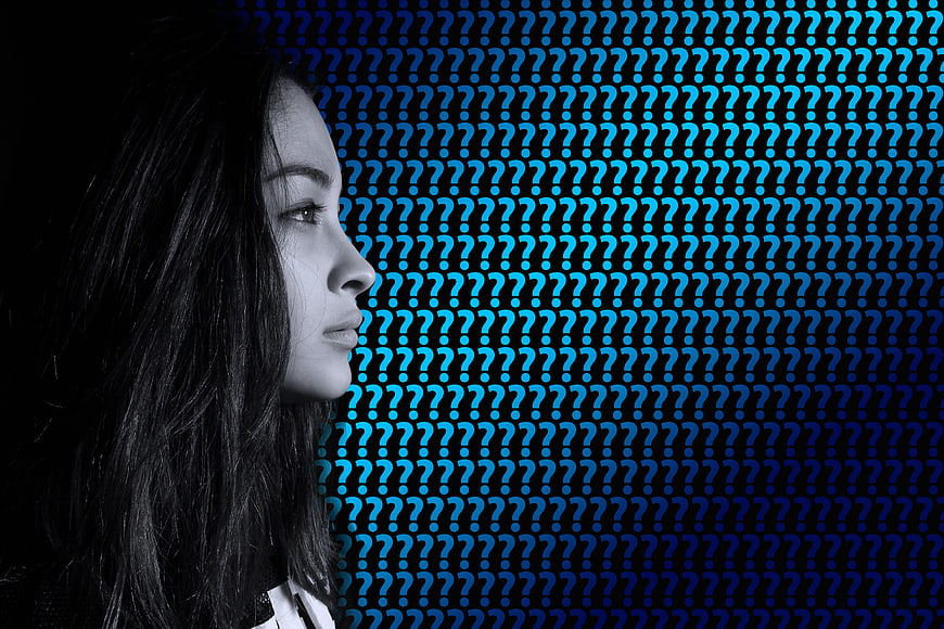 Woman Profile Against Blue Question Mark Background