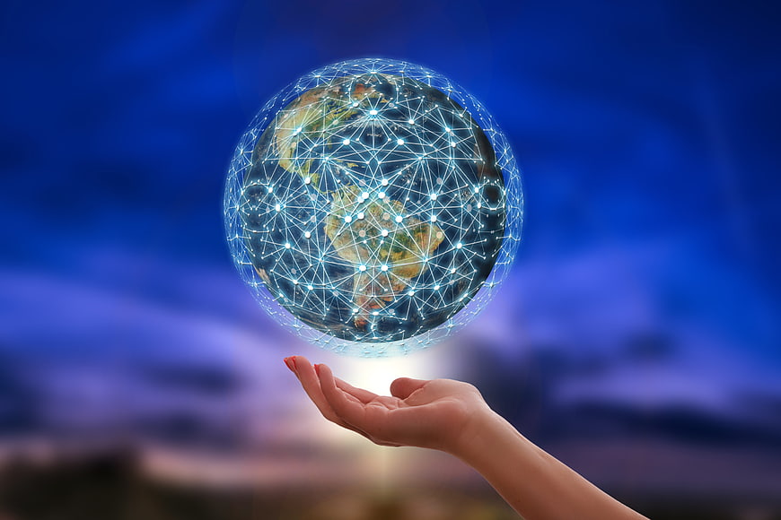 Hand holding digital globe with network connections