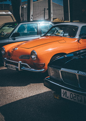 Vintage Orange Sports Car Parked in Lot