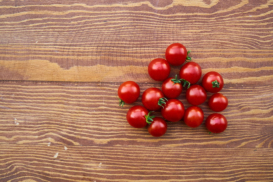 Fresh Red Cherry Tomatoes on Wooden Background