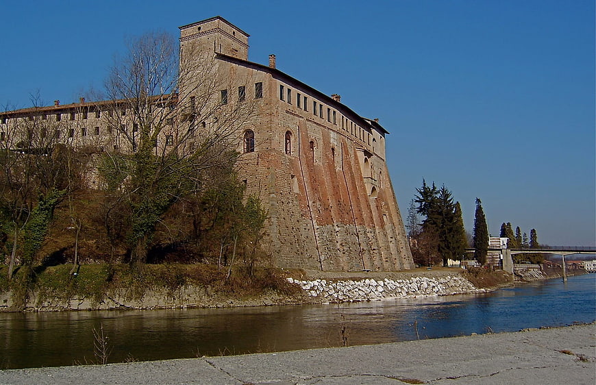Historic Medieval Castle on Riverbank Under Blue Sky