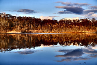 Serene Lake Reflection with Golden Forest and Blue Sky