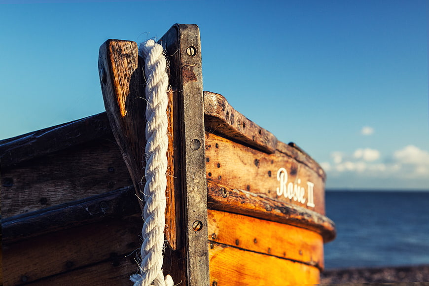 Close-up of wooden fishing boat named Rosie II on beach