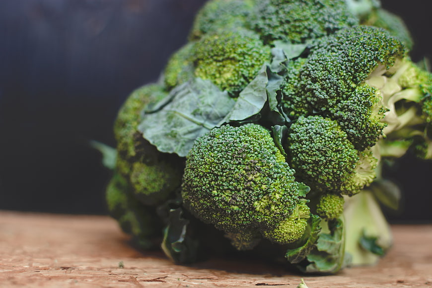Fresh Green Broccoli Head on Wooden Surface