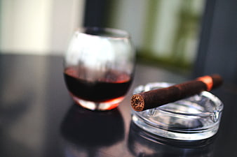 Cigar on Ashtray with Glass of Red Wine