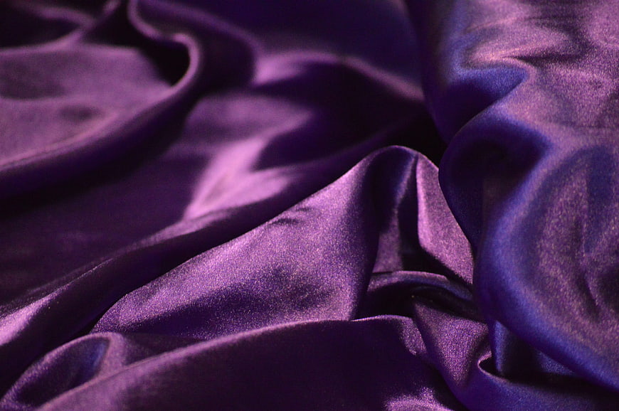 Close-up of luxurious purple satin fabric texture