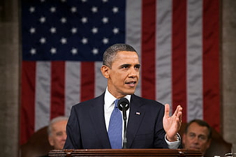 Barack Obama Speaking at Podium with US Flag