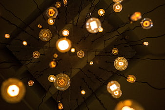 Warm glowing string lights on dark textured background