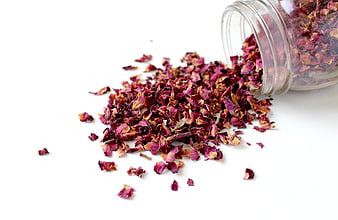 Dried Rose Petals Spilling from Glass Jar on White Background