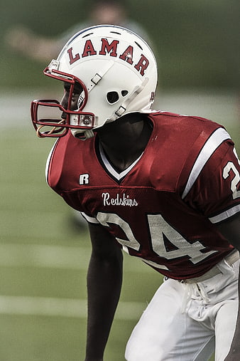 American Football Player in Maroon Uniform on Field