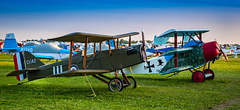 Vintage WWI Military Biplanes Parked On Grass At Airshow