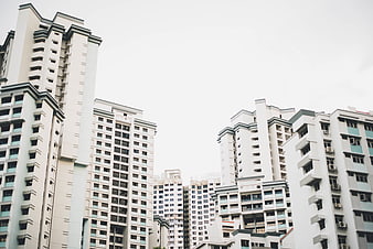 Low angle view of modern white apartment buildings against sky