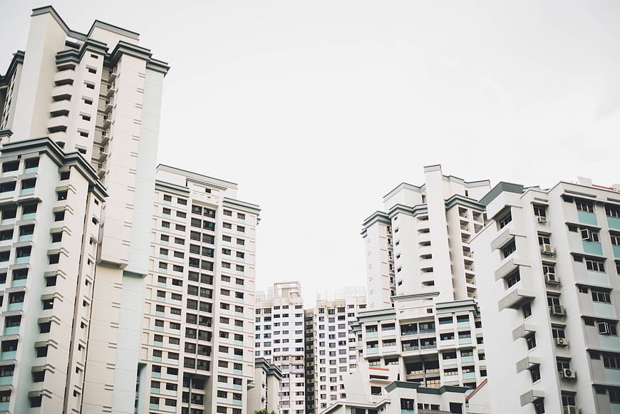 Low angle view of modern white apartment buildings against sky