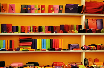 Colorful Leather Wallets and Bags on Orange Shelves