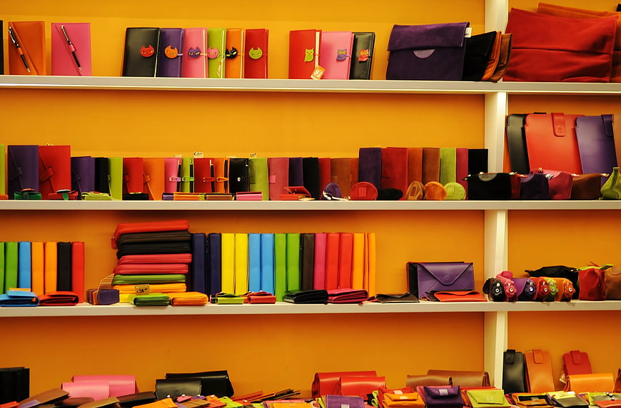 Colorful Leather Wallets and Bags on Orange Shelves