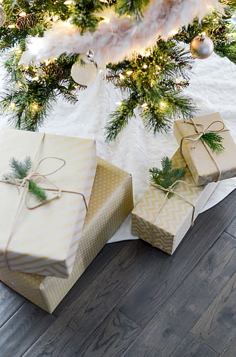 Christmas gifts under tree with lights and ornaments
