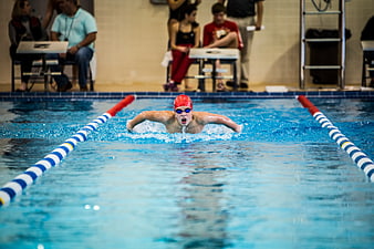Young male swimmer performing butterfly stroke in pool