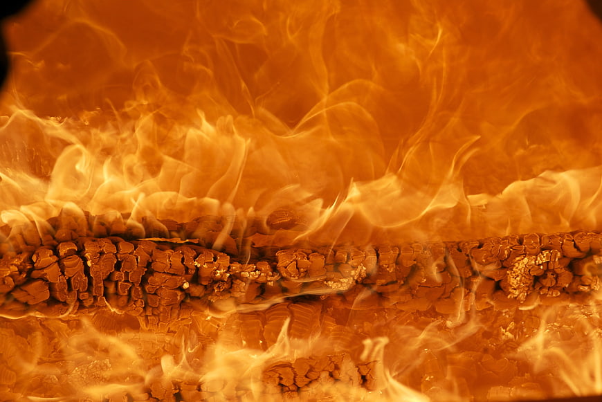 Close-up of burning wood logs with intense orange flames