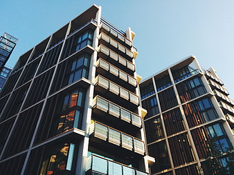 Modern apartment buildings with balconies against blue sky