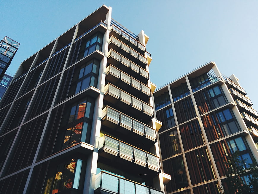 Modern apartment buildings with balconies against blue sky