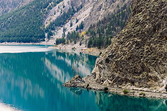 Turquoise Mountain Lake with Cliffside Railway Track