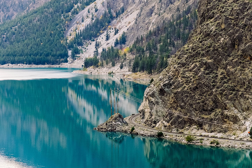 Turquoise Mountain Lake with Cliffside Railway Track