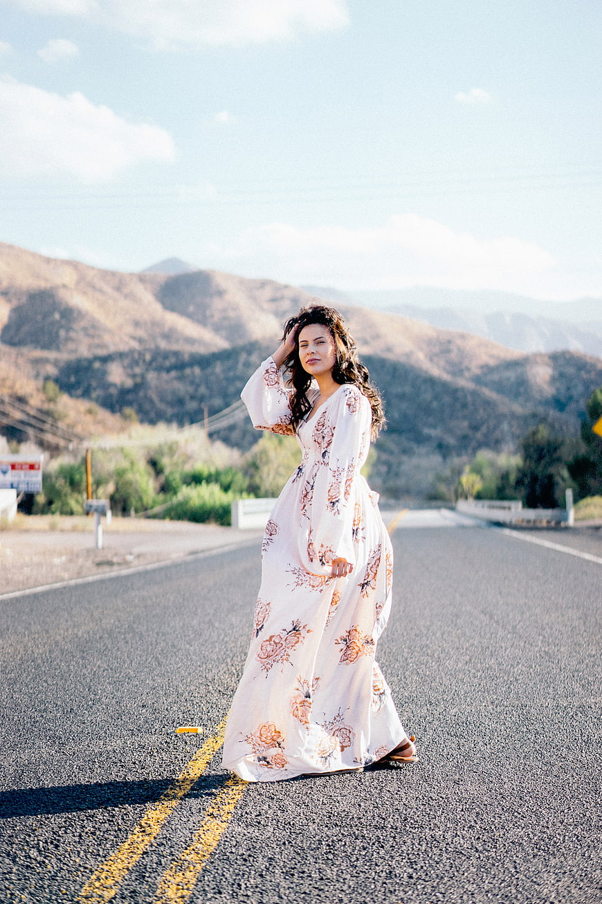 Woman in Floral Maxi Dress Standing on Mountain Road