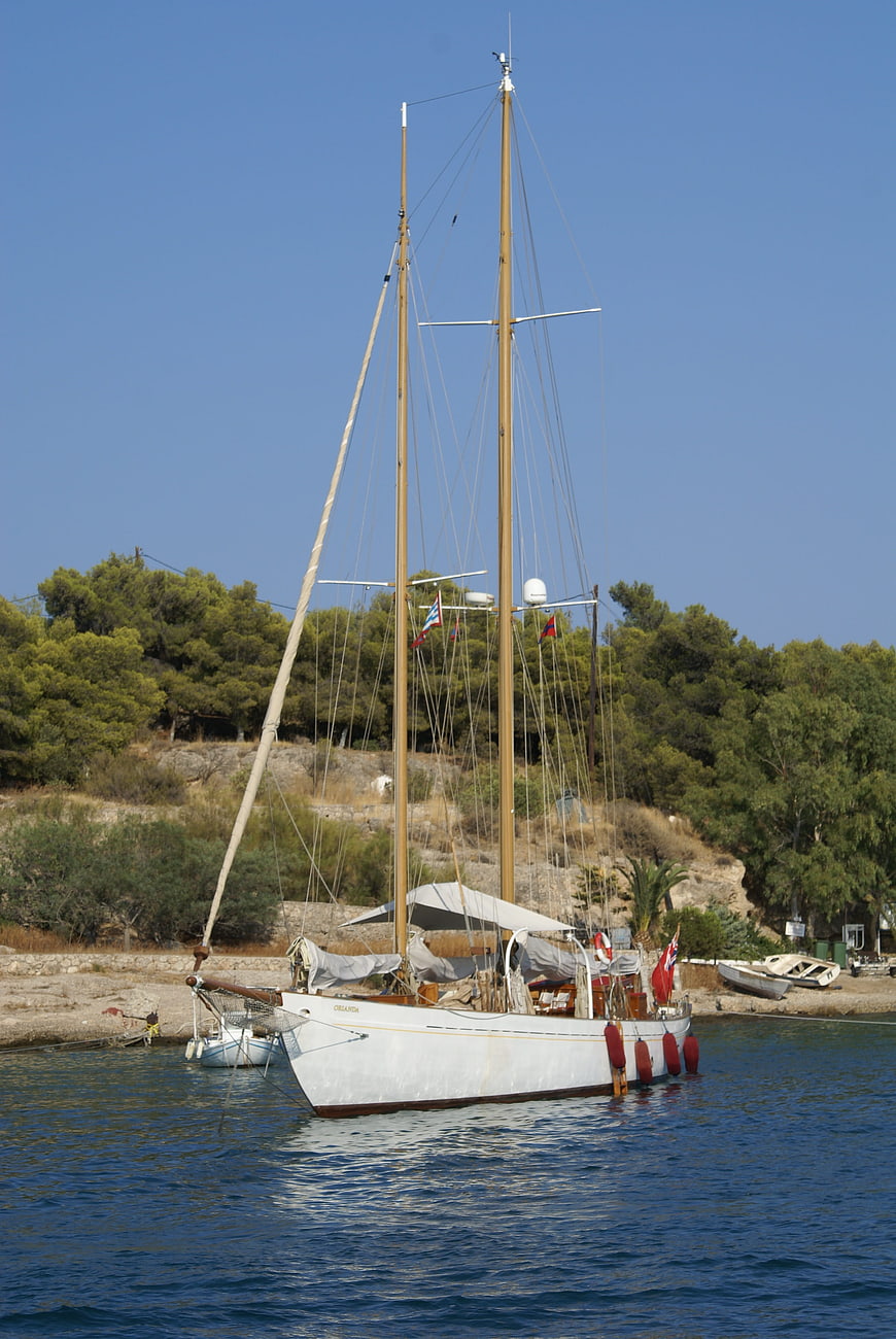 Classic Two-Masted Sailboat Anchored in Greek Harbor