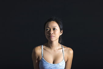 Portrait of Asian Woman in Gray Tank Top on Black Background